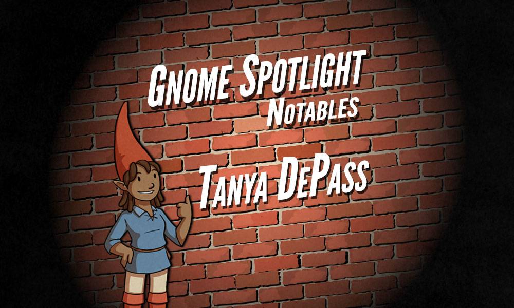 Gnome Spotlight Notables - Tanya DePass : A female gnome with a darker skin color stands with a thumbs up against a brick wall. The text is projected on the background, with a very noir spotlight feeling. 